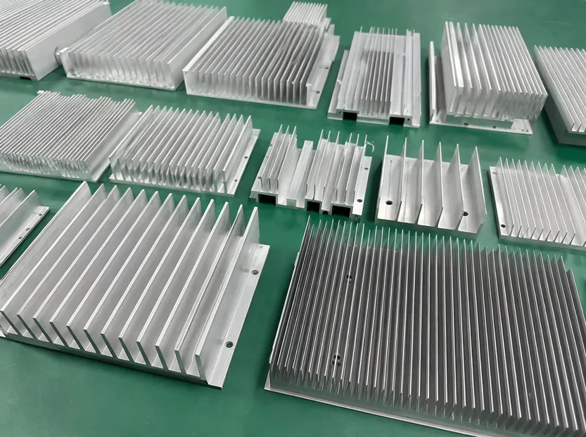 CNC-machined 6063-T5 aluminum heatsink fins showing per-model fin geometry for LED flood light thermal management