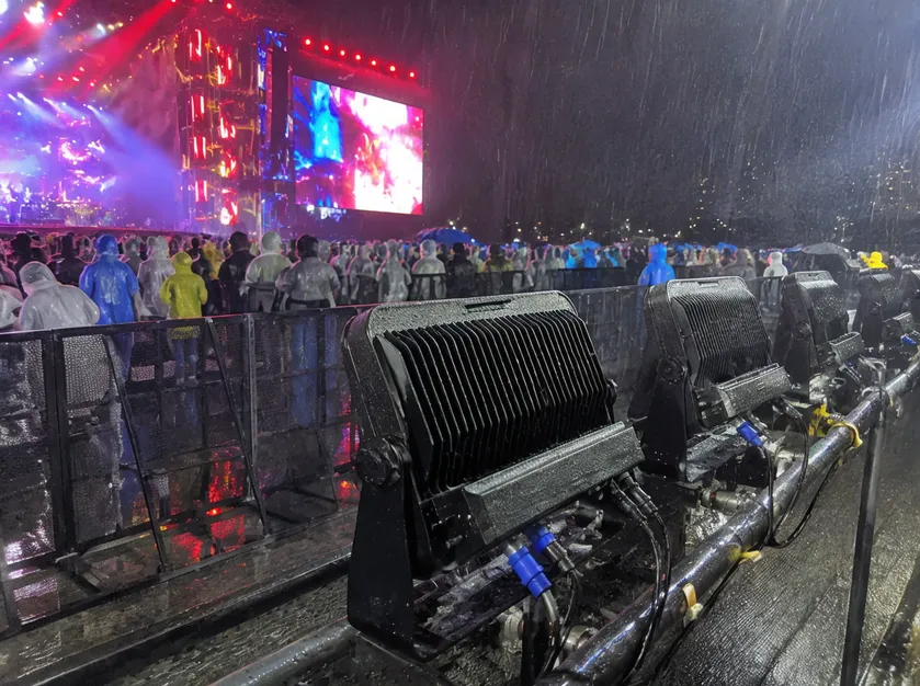 IP65-rated flood light operating in outdoor festival rain conditions