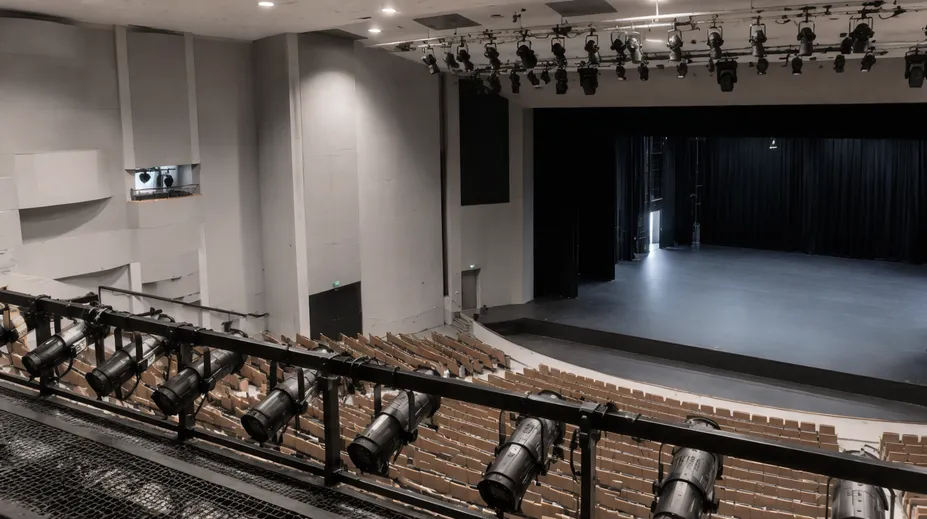 Professional performing arts center with installed profile spotlights across FOH and overhead positions