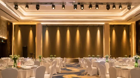 Hotel ballroom with warm golden accent spotlights for event lighting